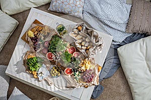 Top view cosiness lounge interior with serving table ready for party celebrating hygge boho scandi