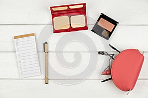 Top view of cosmetics on wood background