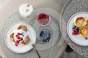 Top view of cottage cheese pancakes with blueberries and raspberries