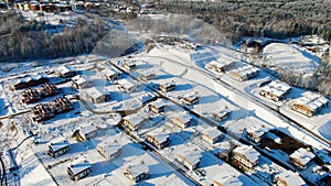 Top view of country houses in winter. Motion. Aerial view forest and detached houses in winter