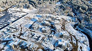 Top view of country houses in winter. Motion. Aerial view forest and detached houses in winter