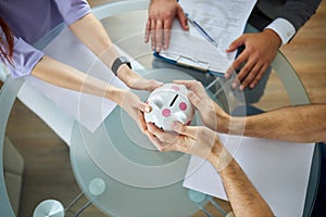 Top view on couple dividing property, hold money box in hands photo