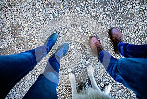 top view of couple feet and their dog