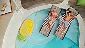 Top View Of Couple At Pool. Happy Man And Woman Enjoying Summer Vacation Or Honeymoon At Tropical Villa.