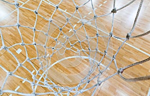 Top view of a court through the basketball hoop net