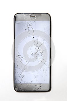 Top view at cracked broken mobile phone screen glass