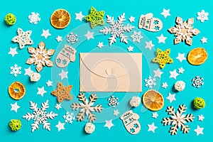 Top view of craft envelope on blue background with New Year toys and decorations. Christmas time concept