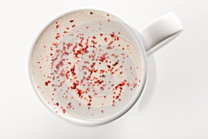 Top view of Craft latte coffee with berries powder on top in white ceramic mug. White background. Best for commercial. Content for