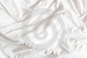 Top view of the crease of an unmade bed sheet in the bedroom. photo