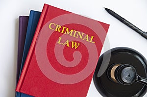 Top view of Criminal Law book with gavel on white background.