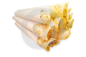 Top view of Crispy fried thin roti with sweetened condensed milk on top, rolled inside paper,ready to serve for snack focus