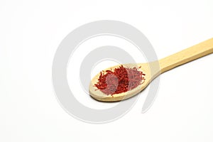 top view of crocus saffron threads in wood spoon isolated on white background