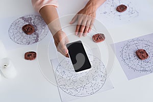 top view of cropped astrologist holding photo