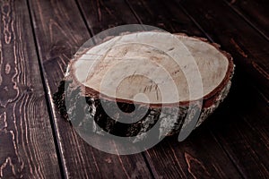 Top view cross section of birch tree trunk on wooden table, template for inserting an item on the background