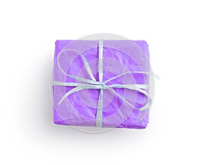 Top view of crumpled paper lavender color present box with recycled paper ribbon isolated on white