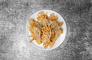 Top view Crunchy fried Enoki Mushroom on the grey concrete table