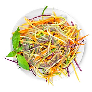 Top view of cucumber, zucchini, carrots vegetables julienned for salad in plate  on white background, concept raw