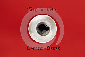 Top view of cup of black coffee and Take a little coffee break lettering isolated on red background