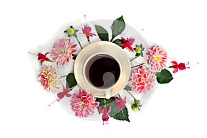 Top view of a cup black tea with flowers dahlia and fuchsia triphylla on a white background. Flat lay