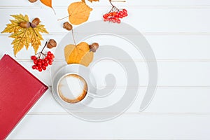 Top view of cup of cappuccino on autumn background.