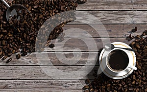 Top view of cup of coffee and coffee beans over the vintage wood background