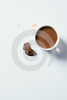 top view of cup of coffee with bitten chocolate chip cookie