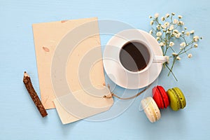 Top view of cup of coffee with colorful macaron