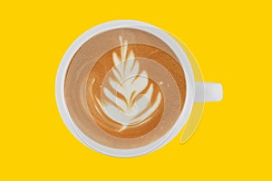Top view of cup of coffee latte on colour background