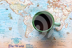 Top view of cup coffee one the word map for Traveler accessories and items man with backpack and visiting for planning travel vaca