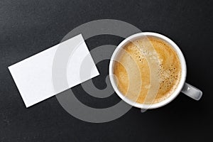 Top view of cup with espresso and white business card template