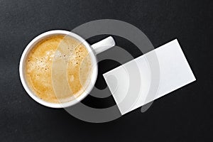 Top view of cup with espresso and white business card template