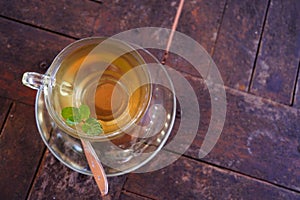 Top view of a cup of green tea on the wooden surface