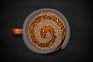 Top view of a cup of instant coffee on a black background, close up