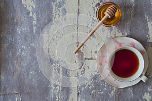 Top view of cup of red tea with honey