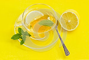 Top view of cup of tea with mint and lemon
