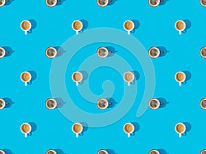 Top view of cups of fresh coffee on blue