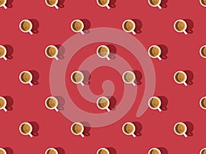 Top view of cups of fresh coffee on red
