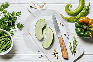 top view of cut cucumber on white wooden