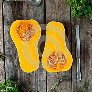 Top view Cut ripe orange pumkin with seeds on the rustic wooden table. Vegetarian, vegan, healthy diet food. Autumn harvest concep