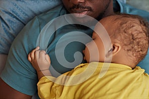 Top view cute little baby sleeping on fathers chest at naptime photo
