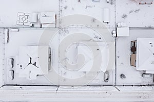 Top view of dacha houses roofs under snow