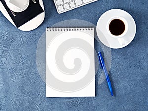 Top view of dark blue desktop with microscope, notepad, computer. Mock up, empty space, science template