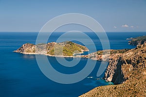 A top view at dark blue Ionian Sea, Asos village and Assos peninsula from a road. Aerial view, summer scenery of famous and
