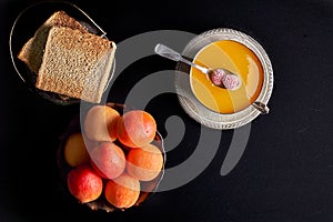 Fresh apricots, homemade apricot jam, toasted bread toast with jam, photo
