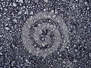 Top view dark grey fresh new asphalt road texture with small rocks