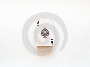 Top view of a deck of playing cards with an ace with a spade suit on top isolated on a white background. The concept of games,