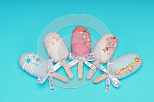 top view of decorated cake pops ice creams on turquoise background