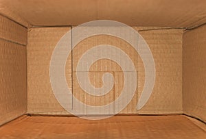 Top view of deep empty cardboard box, opened brown paper carton box, empty cardboard box close up, inside view