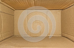 Top view of deep empty cardboard box, opened brown paper carton box, empty cardboard box close up, inside view