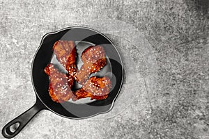 Top view Deep fried chicken wing with Korean sauce on the gray concrete table